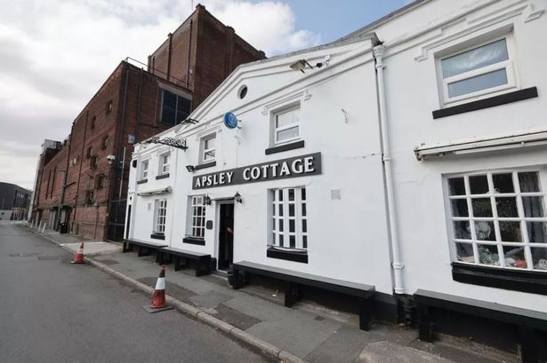 The Apsley Cottage pub in Ardwick with the Apollo Theatre looming behind.