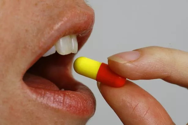 Person taking a tablet