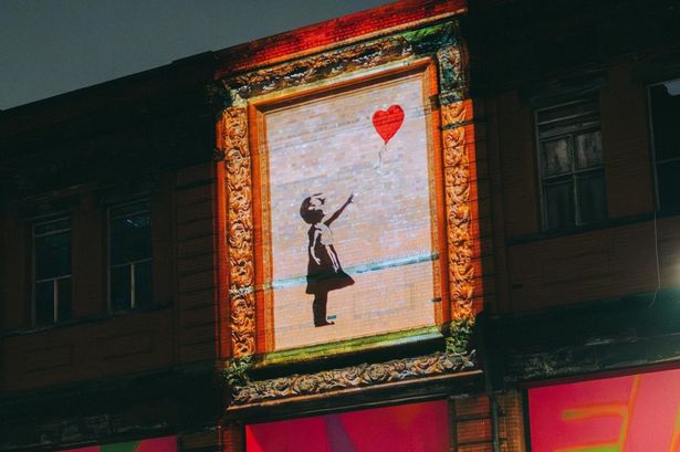 Banksy images have been projected across Manchester city centre