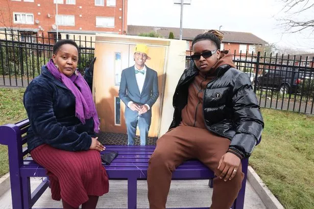 Eddie's mum, Irene Muthemba, and brother, Elliot, sit on the memory bench within Eddie King Park.