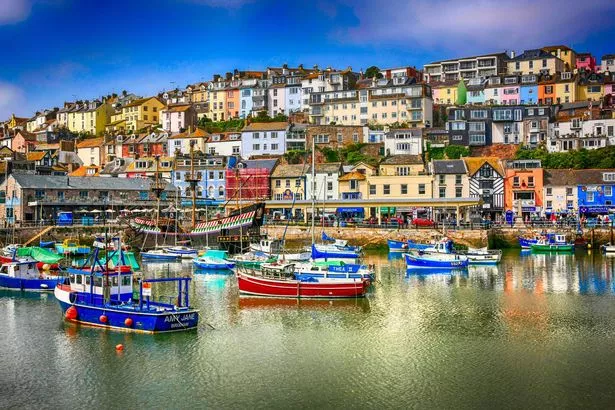 Brixham, United Kingdom - May 2, 2012: Colorful hillside homes overlooking the harbor at Brixham, UK