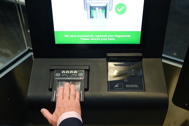 An employee scans fingerprints during a demonstration of the new Entry/Exit System, known as EES, at the Eurotunnel terminal in Folkestone, UK, on Tuesday, Sept. 23, 2025.