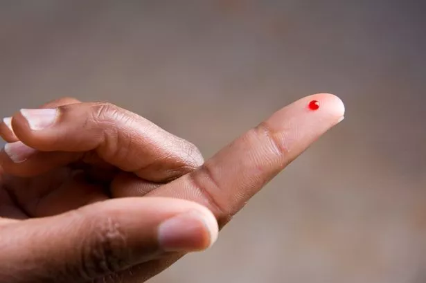 Drop of blood on finger