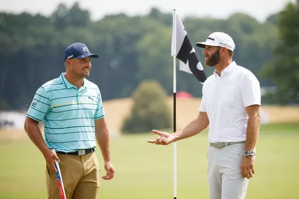 Bryson DeChambeau of Crushers GC and Dustin Johnson of 4 Aces GC talk on the 18th green during the pro-am prior to the LIV Golf Invitational - Bedminster at Trump National Golf Club Bedminster on July 28, 2022 in Bedminster, New Jersey.
