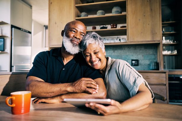 Older couple sat in kitchen together