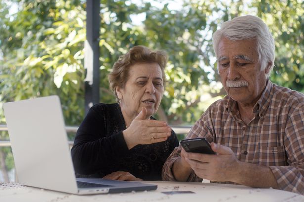 Senior couple sorting through finances