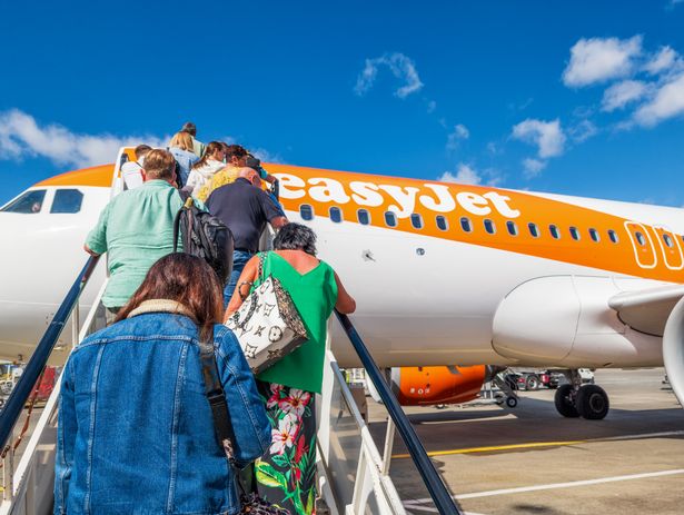 A view of people climbing the stairs to board an Easyjet flight.
