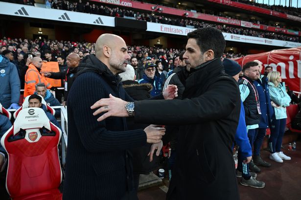 Pep Guardiola, Manager of Manchester City, embraces Mikel Arteta, Manager of Arsenal, prior to the Premier League match between Arsenal FC and Manchester City
