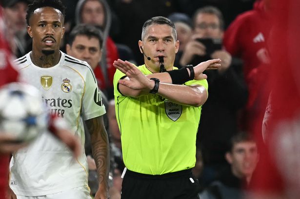 Istvan Kovacs indicates no penalty after consulting a pitch-side monitor during Liverpool's Champions League clash with Real Madrid.