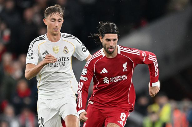 Dominik Szoboszlai of Liverpool breaks away from Dean Huijsen of Real Madrid at Anfield on November 4 2025
