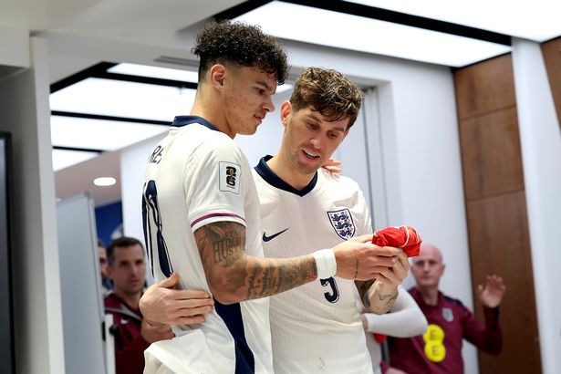 LONDON, ENGLAND - NOVEMBER 13: Nico O'Reilly of England is presented with a legacy cap by teammate John Stones following the FIFA World Cup 2026 qualifier match between England and Serbia at Wembley Stadium on November 13, 2025 in London, England. (Photo by Eddie Keogh - The FA/The FA via Getty Images)