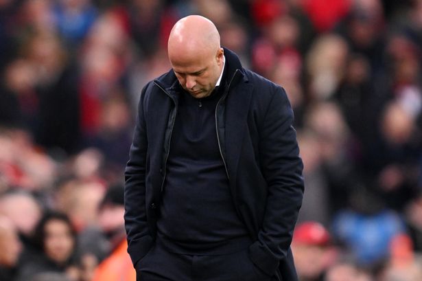 Arne Slot looks down in the technical area