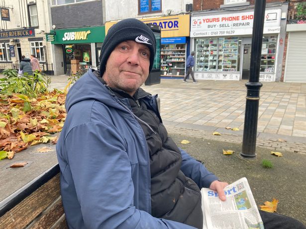 Paul Warrington, sat reading a newspaper in Middleton Gardens