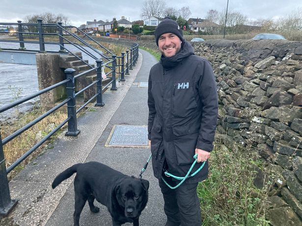 Rich Oddy, 50, with Toby the black Lab