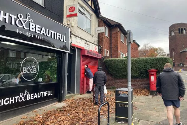 Queues for the cashpoint at the shuttered Watts Lane Post Office, Bootle.