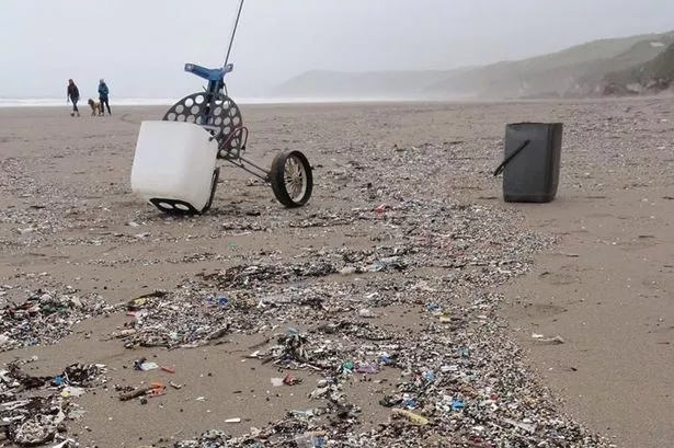 Tiny bits of plastic spread across the sand