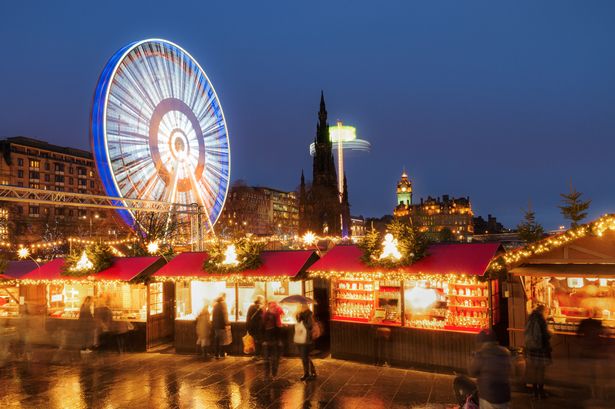 People browsing winter market stalls, just off Princes Street in Edinburgh's city centre during the run-up to Christmas and Hogmanay, the city's famous New Year's celebrations.