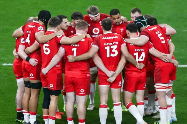 Wales huddle before the match