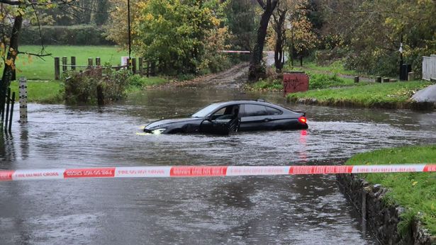 A car is stranded in Green Road ford in Hall Green, Birmingham during Storm Claudia