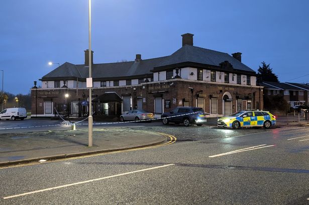 A police cordon outside the Oak Tree pub in Huyton after someone was shot in the leg on nearby Radway Road