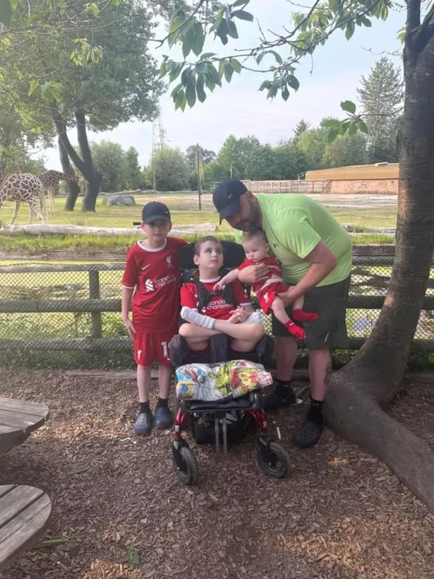 Jacob Rimmer (centre) with his dad Kevin and his two brothers, Joel and Joseph
