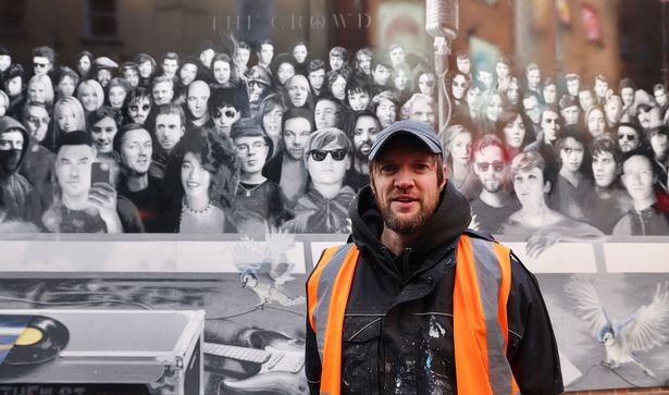 Joseph Venning with the new mural of 100 musicians on Mathew Street 