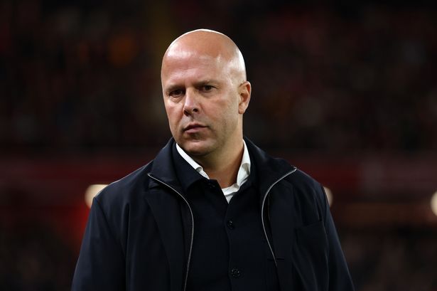 Arne Slot looks on from the touchline