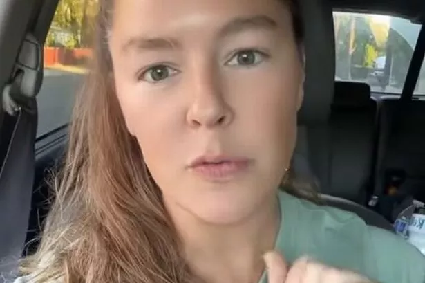 Nichole Andrews, a registered dietitian nutritionist, speaks to the camera while sitting in her car