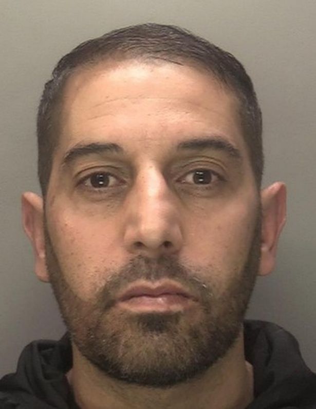 Police custody image of Noor Khan, who ran the Noor Line, pictured with shaved brown hair and a trimmed beard and black top 