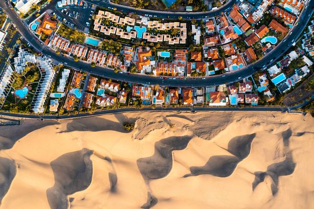 Overhead view of cityscape and sand dunes in Maspalomas, Grand Canary, Spain