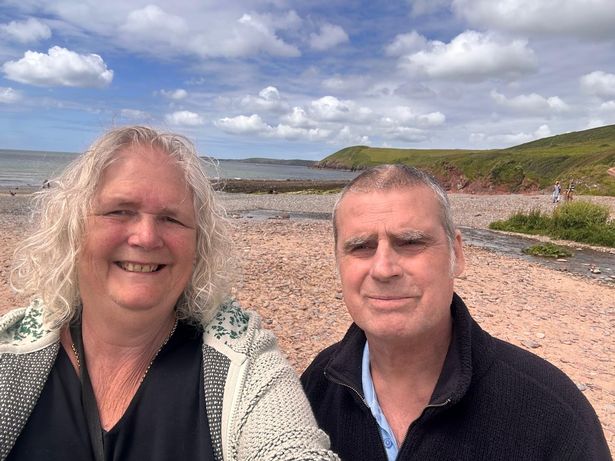 Mark with his wife Rosalind on the beach