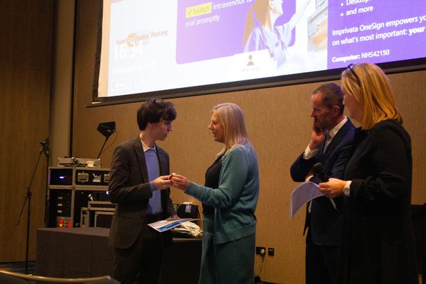 Harry Ross receives his award from Victoria Bagshaw