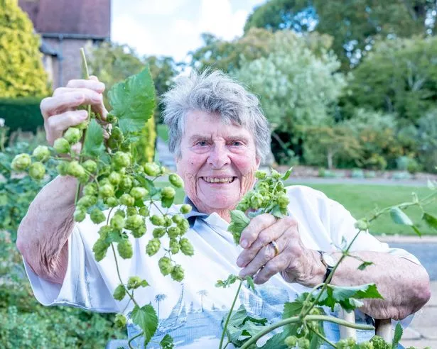 A woman holding hops