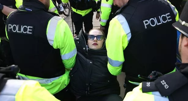 Police arrest protesters on College Green in Bristol on Saturday, November 29, 2025, for writing placards saying: 'I oppose genocide - I support Palestine Action'
