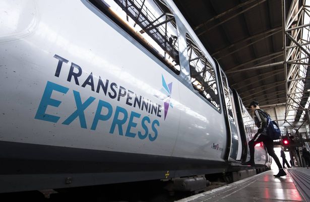 A man boarding a Transpennine Express train 