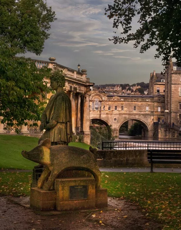 statue of the legendary Prince Baldud and one of his herd of pigs, in the Parade Gardens in downtown Bath, England, a World Heritage site, along the River Avon