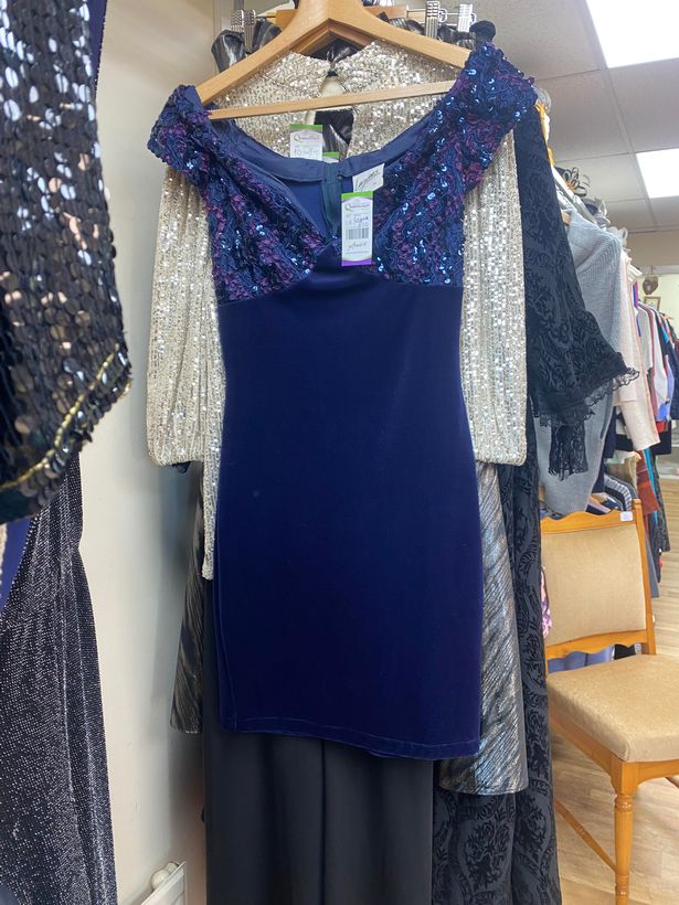 Blue short sequin dress in a charity shop 