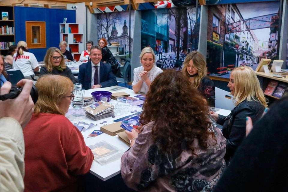 Volunteers including Michelle O'Neill pack the cards