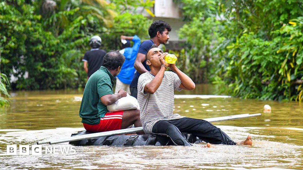 People navigate floodwaters on a makeshift raft as heavy rains from Cyclone ''Ditwah'' sweep through Colombo, Sri Lanka, on 29 November 2025.
