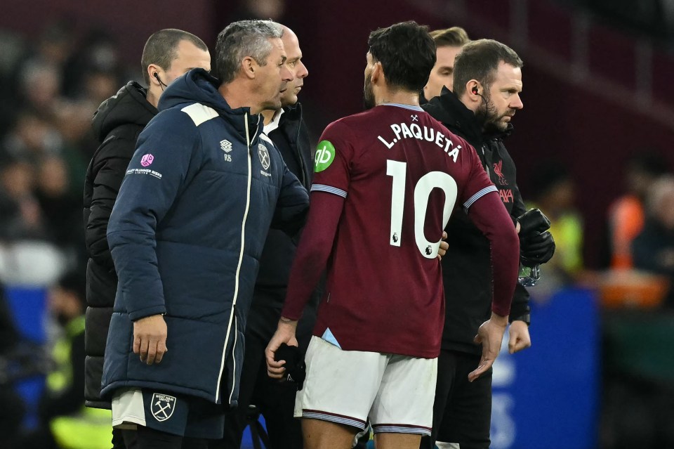 West Ham United’s Brazilian midfielder #10 Lucas Paqueta has words with the fourth official as he leaves the game having been sent off during the English Premier League football match between West Ham United and Liverpool at the London Stadium, in London on November 30, 2025.