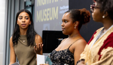 One female student turned and gesturing to two others on stage during the Night at the Museum event.