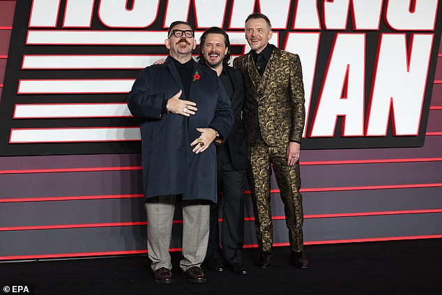 The trio tried to keep composed while posing for photos