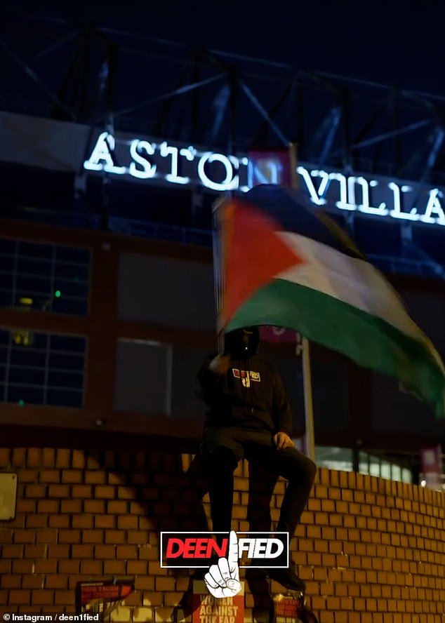 One of the protesters can be seen sitting on the exterior wall of the stadium waving a Palestinian flag, as just metres away - through the bars of the railings - an Aston Villa security guard can be seen walking around the pitch