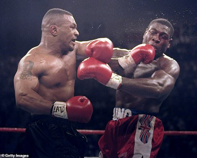 Mike Tyson connects with Bruno in their 1996 world title fight, which Tyson won via technical knockout in the third round