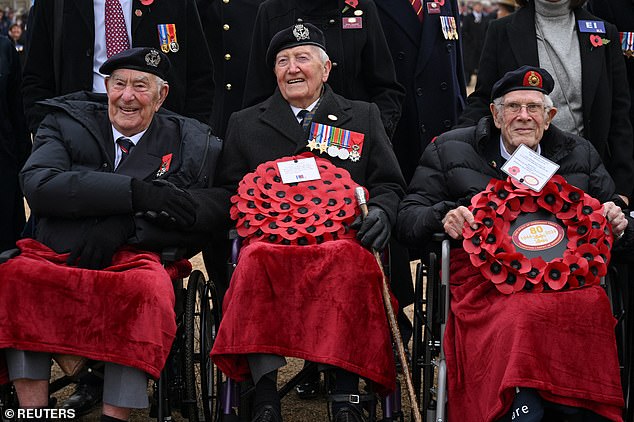 Pictured: World War Two veterans shaking hands at the Horse Guards Parade in London last year on Remembrance Day