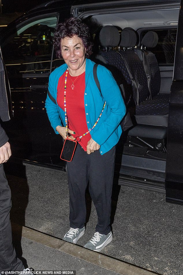 She opted for a casual look ahead of the lengthy flight, dressing in casual black trousers, a blue cardigan and a red top