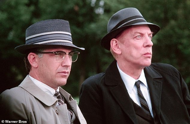 Costner has played other historical figures, including Eliot Ness in The Untouchables (1987) and Jim Garrison in JFK (1991); Pictured with Donald Sutherland in a still from JFK