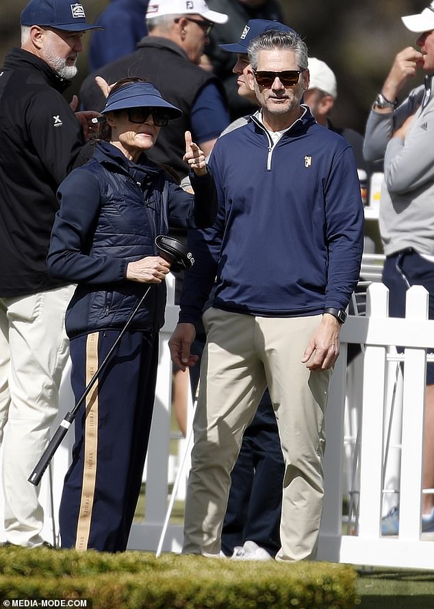 Watching on was Aussie actor Eric, 57, who kept things casual in a black jumper and beige khaki slacks