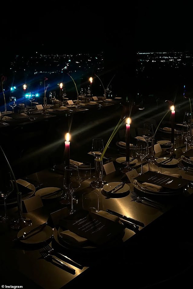 Attendees took their seats at long tables decked out with place cards, candles, intricate table settings and traditional olive martinis