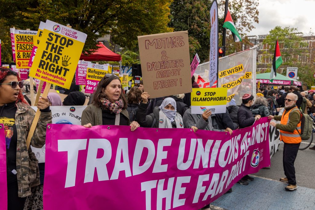 Women stand behind a banner reading "Trade Unions Against the Far Right", holding placards such as "Mothers and Daughters Against Fascist", "Stop the Far Right, No Islamophobia No antisemitism", "Jewish Socialists" and "Stop Islamophobia". 